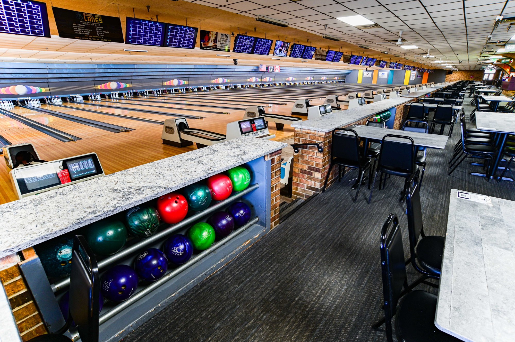 The bowling lanes at BOWL ONE LANES in Troy, lit up and ready for play